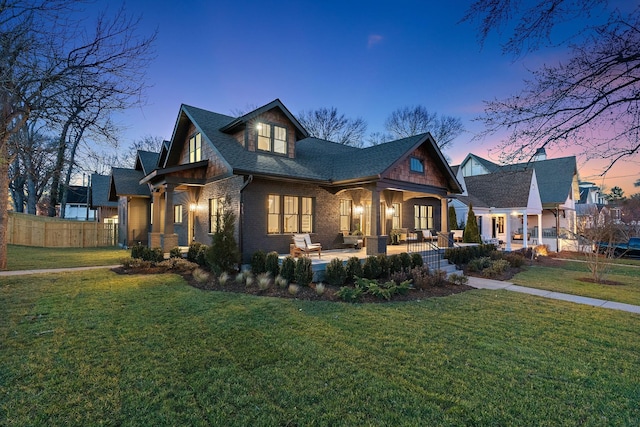 view of front of property with brick siding, roof with shingles, and covered porch