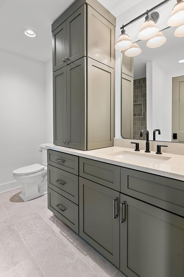 bathroom featuring toilet, baseboards, vanity, and recessed lighting