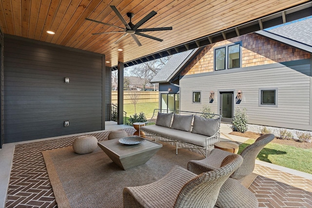 view of patio with ceiling fan, outdoor lounge area, and fence