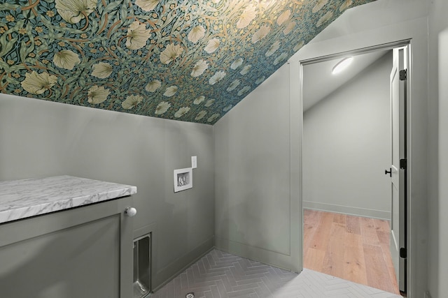 laundry area featuring washer hookup, light wood-style flooring, and baseboards