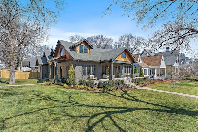 craftsman-style house with covered porch, a shingled roof, and brick siding