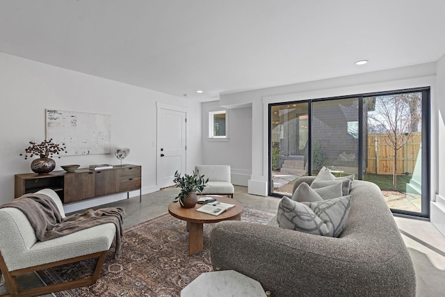 living room with concrete flooring and recessed lighting