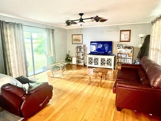 living room featuring wood finished floors, crown molding, and a ceiling fan