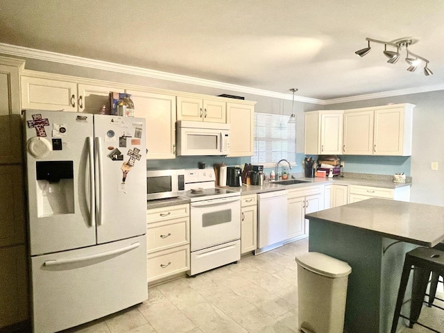 kitchen featuring white appliances, a sink, ornamental molding, decorative light fixtures, and a breakfast bar
