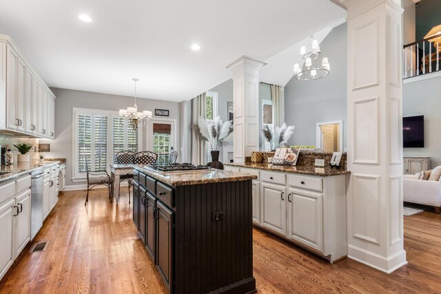 248 Stonehaven Cir, Franklin, TN 37064 - kitchen with a chandelier, stainless steel appliances, white cabinetry, light wood-style flooring, and dark stone counters