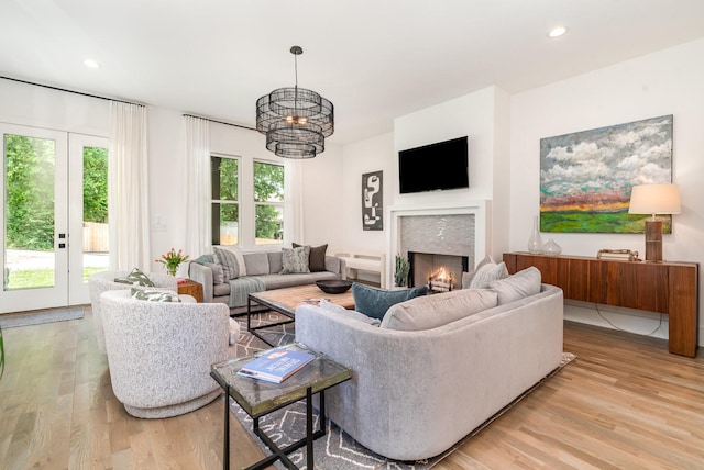 1411A Boscobel St, Nashville, TN 37206 - living room with light wood-style floors, a warm lit fireplace, recessed lighting, and a chandelier