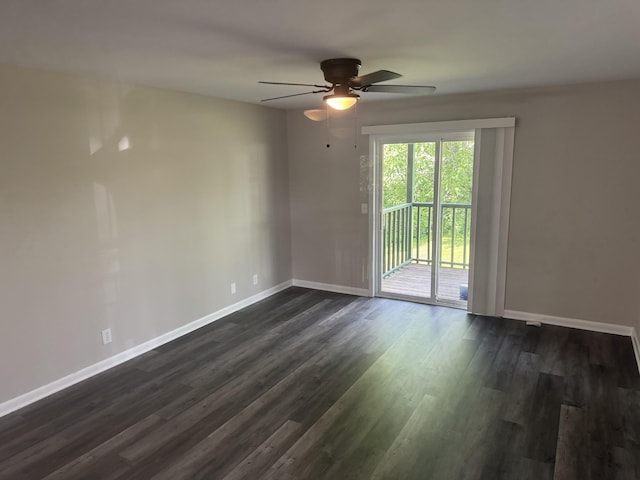 spare room featuring baseboards, a ceiling fan, and dark wood-type flooring