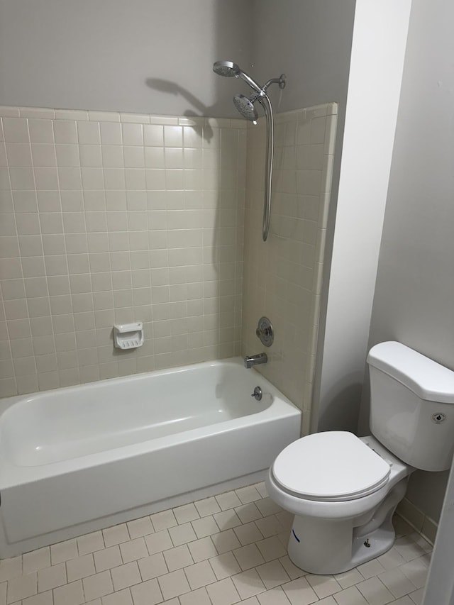 full bath featuring toilet, tile patterned floors, and shower / tub combination