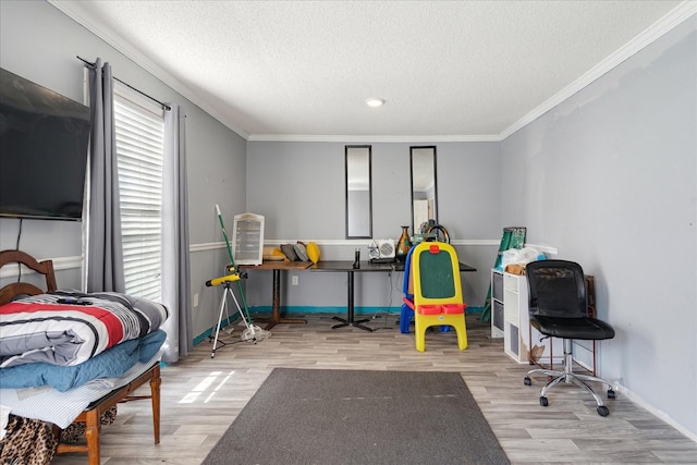 1505 Roane St, Covington, TN 38019 - recreation room featuring wood finished floors, baseboards, a textured ceiling, and crown molding
