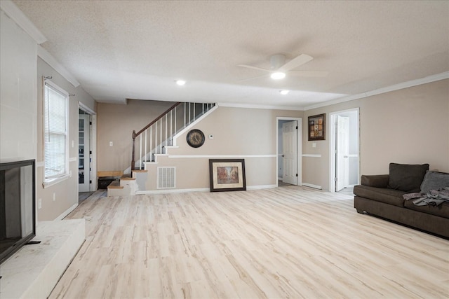 1505 Roane St, Covington, TN 38019 - living room with ornamental molding, ceiling fan, wood finished floors, stairway, and baseboards