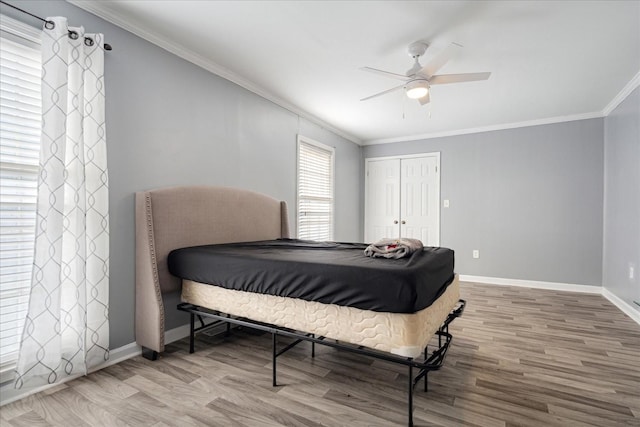 1505 Roane St, Covington, TN 38019 - bedroom featuring wood finished floors, ornamental molding, baseboards, a closet, and ceiling fan