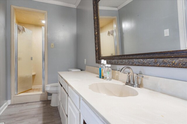 1505 Roane St, Covington, TN 38019 - full bath featuring ornamental molding, toilet, a shower stall, wood finished floors, and vanity