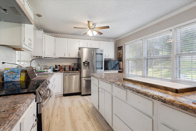 1505 Roane St, Covington, TN 38019 - kitchen featuring stainless steel appliances, a ceiling fan, a textured ceiling, light wood-style flooring, and white cabinetry