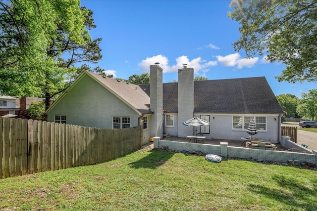 1505 Roane St, Covington, TN 38019 - back of house with a chimney, brick siding, a patio, and roof with shingles