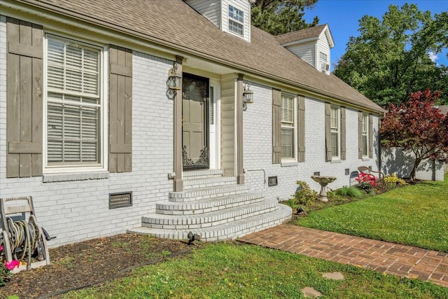 1505 Roane St, Covington, TN 38019 - doorway to property featuring brick siding, a shingled roof, a yard, and crawl space