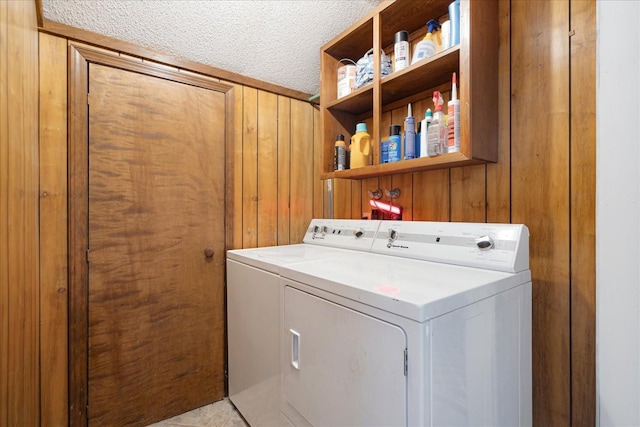 1505 Roane St, Covington, TN 38019 - clothes washing area with washer and clothes dryer, wooden walls, and a textured ceiling