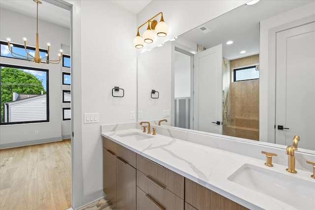 2010B 9th Ave N, Nashville, TN 37208 - full bath featuring plenty of natural light, a chandelier, a tile shower, double vanity, and recessed lighting