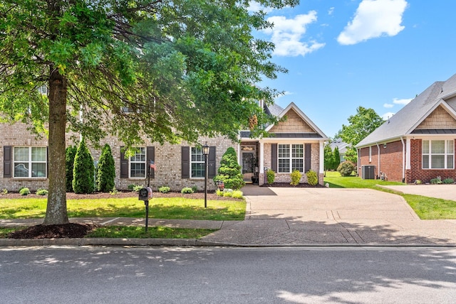 1113 Chickadee Cir, Hermitage, TN 37076 - obstructed view of property with brick siding, central air condition unit, and a front lawn