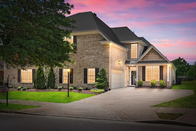 1113 Chickadee Cir, Hermitage, TN 37076 - view of front facade featuring driveway, brick siding, a yard, and an attached garage