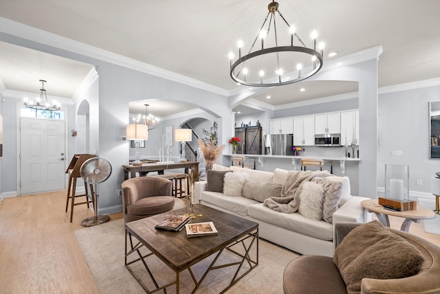 1113 Chickadee Cir, Hermitage, TN 37076 - living area featuring a chandelier, arched walkways, crown molding, light wood-style floors, and baseboards