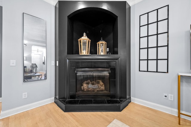 1113 Chickadee Cir, Hermitage, TN 37076 - detailed view of wood finished floors, baseboards, a fireplace with raised hearth, and ornamental molding