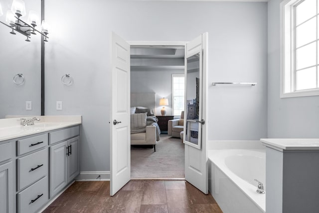 1113 Chickadee Cir, Hermitage, TN 37076 - ensuite bathroom with healthy amount of natural light, vanity, a bath, and wood finished floors