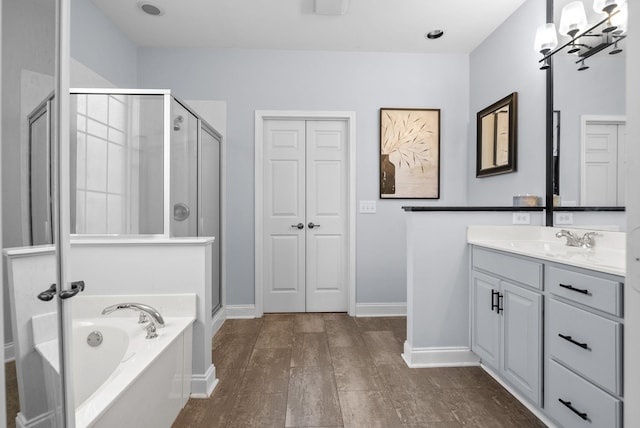 1113 Chickadee Cir, Hermitage, TN 37076 - bathroom with a shower stall, a garden tub, vanity, wood finished floors, and baseboards