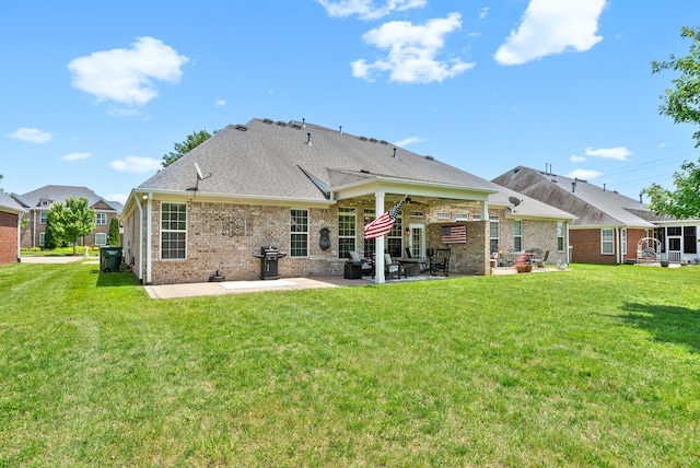 1113 Chickadee Cir, Hermitage, TN 37076 - back of house with a patio, brick siding, and a yard