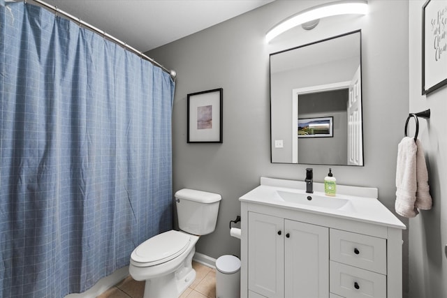 bathroom with toilet, tile patterned floors, vanity, baseboards, and a shower with curtain