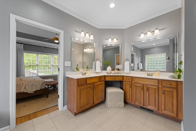 ensuite bathroom featuring ornamental molding, tile patterned flooring, double vanity, and ceiling fan