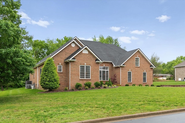 traditional-style home with brick siding and a front yard