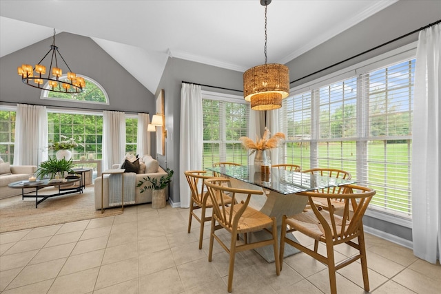 dining space with a chandelier, baseboards, plenty of natural light, vaulted ceiling, and ornamental molding