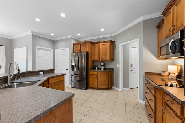 kitchen featuring appliances with stainless steel finishes, a sink, dark countertops, recessed lighting, and brown cabinets