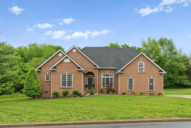 traditional home with brick siding and a front yard