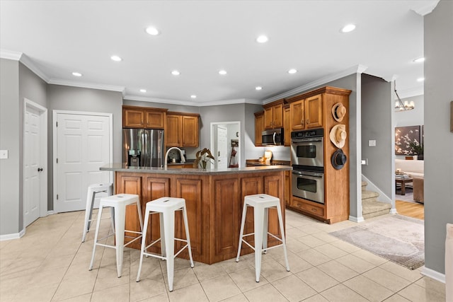 kitchen with appliances with stainless steel finishes, crown molding, brown cabinetry, recessed lighting, and light tile patterned floors