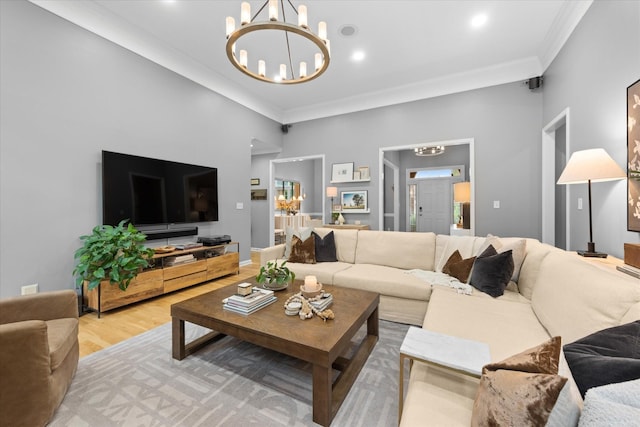 living area with a chandelier, crown molding, wood finished floors, and recessed lighting