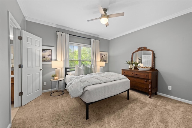 bedroom featuring carpet floors, ornamental molding, baseboards, and a ceiling fan