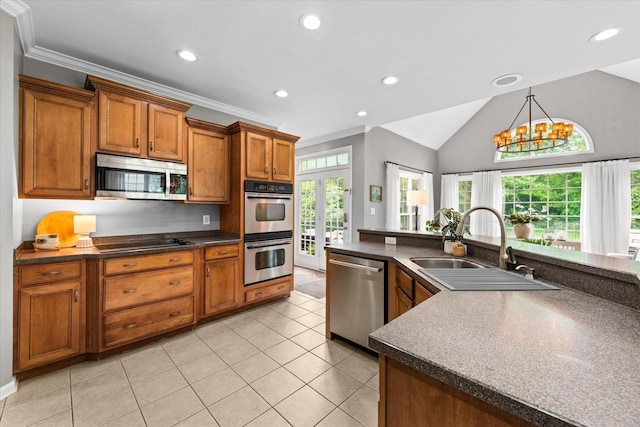 kitchen with stainless steel appliances, a sink, dark countertops, recessed lighting, and vaulted ceiling