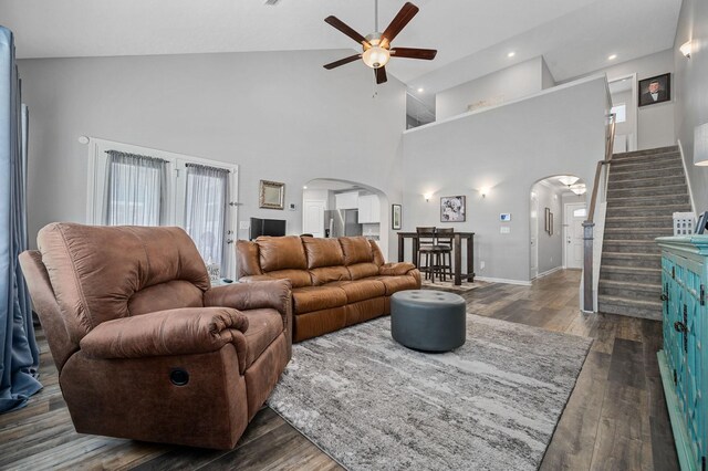 1626 Calcutta Dr, Murfreesboro, TN 37128 - living area featuring arched walkways, a ceiling fan, stairs, high vaulted ceiling, and dark wood-type flooring