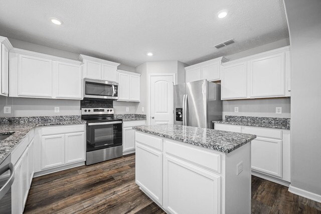 1626 Calcutta Dr, Murfreesboro, TN 37128 - kitchen featuring stainless steel appliances, a kitchen island, white cabinetry, dark wood finished floors, and recessed lighting