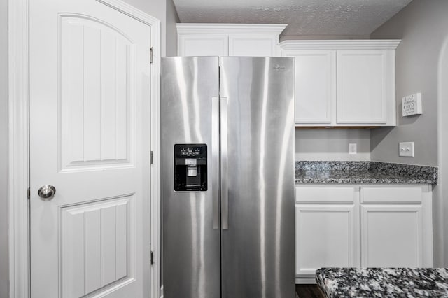 1626 Calcutta Dr, Murfreesboro, TN 37128 - kitchen with stainless steel refrigerator with ice dispenser, white cabinets, dark stone countertops, and a textured ceiling