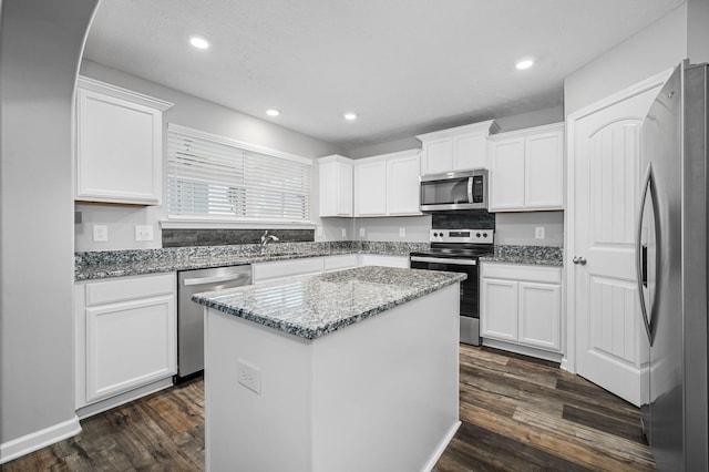 1626 Calcutta Dr, Murfreesboro, TN 37128 - kitchen featuring stainless steel appliances, a kitchen island, dark wood-type flooring, white cabinets, and recessed lighting