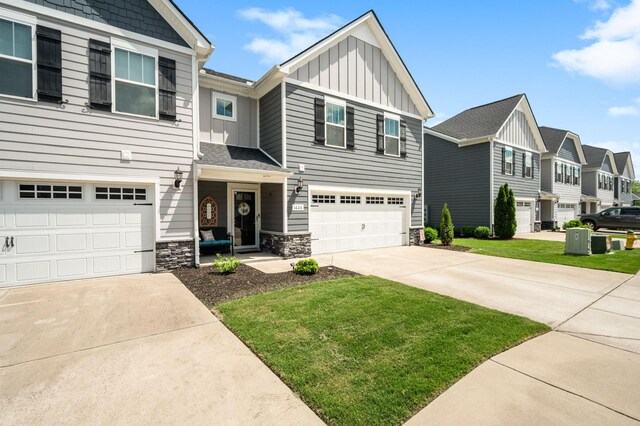 1626 Calcutta Dr, Murfreesboro, TN 37128 - view of front of property with board and batten siding, concrete driveway, a garage, and stone siding