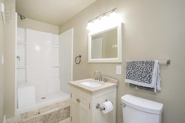 bathroom with a shower, vanity, and toilet