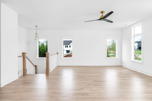 603B Freedom Ct, Nashville, TN 37209 - unfurnished living room featuring light wood-style flooring, a ceiling fan, and baseboards