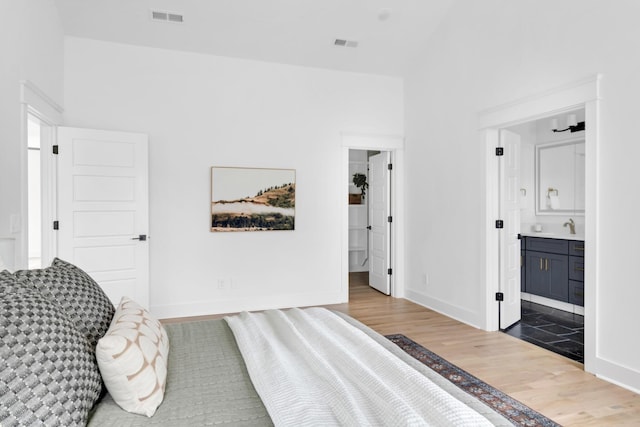 603B Freedom Ct, Nashville, TN 37209 - bedroom featuring wood finished floors, a sink, baseboards, and ensuite bath