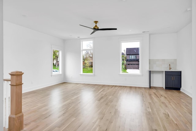 603B Freedom Ct, Nashville, TN 37209 - unfurnished living room featuring light wood-style floors, ceiling fan, baseboards, and a sink