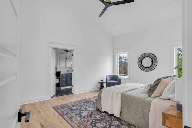 603B Freedom Ct, Nashville, TN 37209 - bedroom with high vaulted ceiling, light wood finished floors, baseboards, ensuite bath, and a ceiling fan