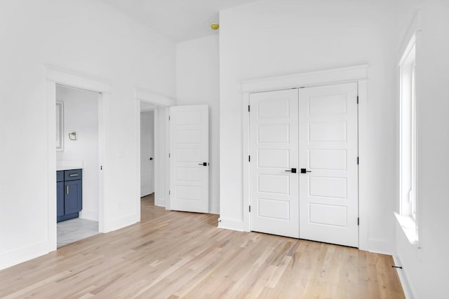603B Freedom Ct, Nashville, TN 37209 - unfurnished bedroom with light wood finished floors, baseboards, a closet, and ensuite bathroom