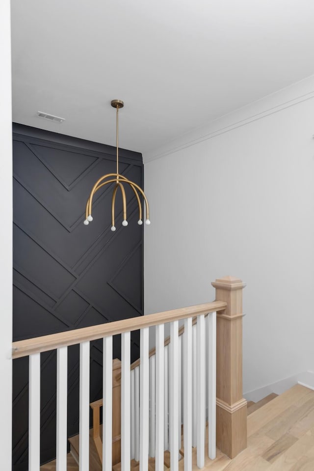 6401 Thunderbird Dr, Nashville, TN 37209 - stairway featuring a chandelier, wood finished floors, and ornamental molding